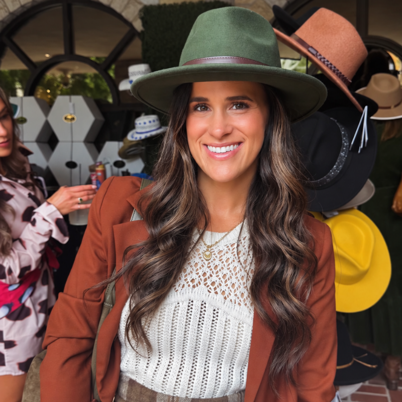 Taylor Rhea smiling in a green hat